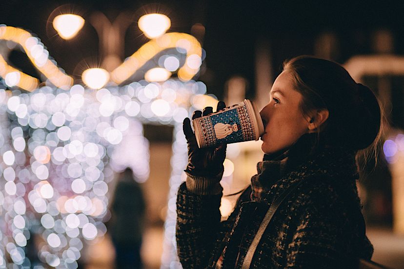 Enjoying a festive beverage at a holiday market